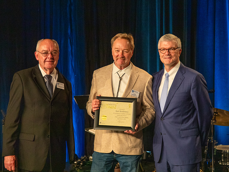 President, CEO and employee receiving award