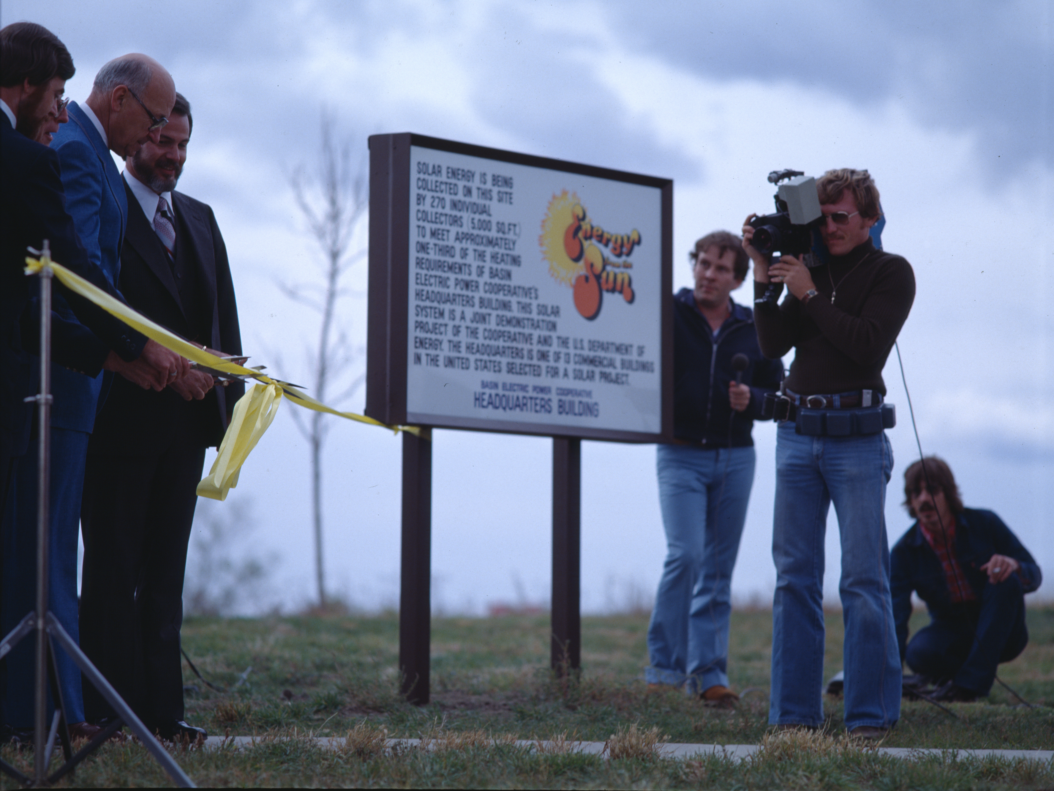 photo of sign about solar project with camera man