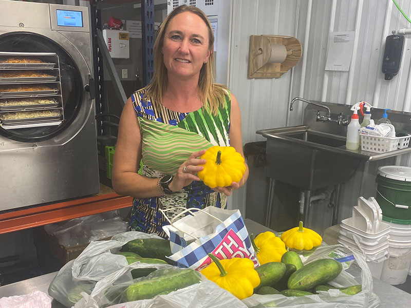 Woman smiling with vegetables