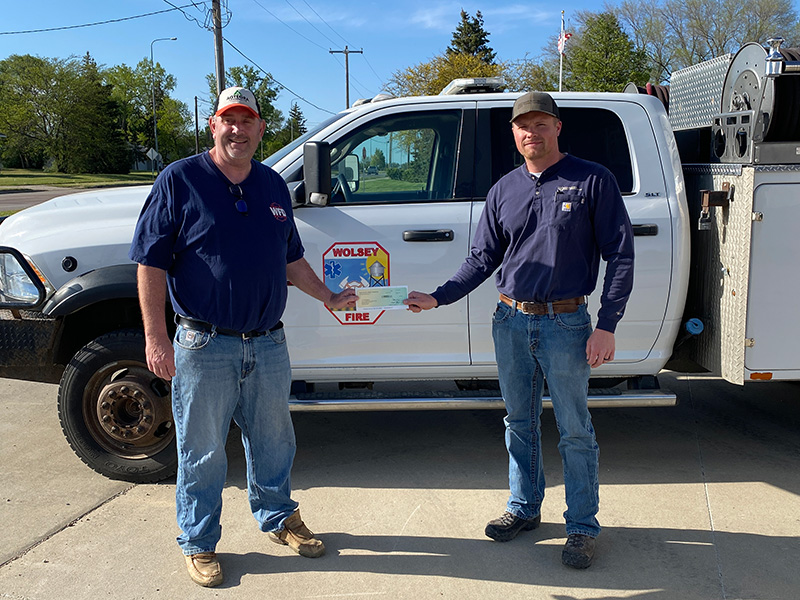 Basin Electric staff presenting Wolsey Fire Department Assistant Chief with donation check