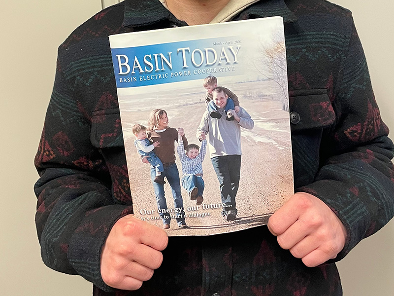 Dawson Kaylor holds an old issue of Basin Today