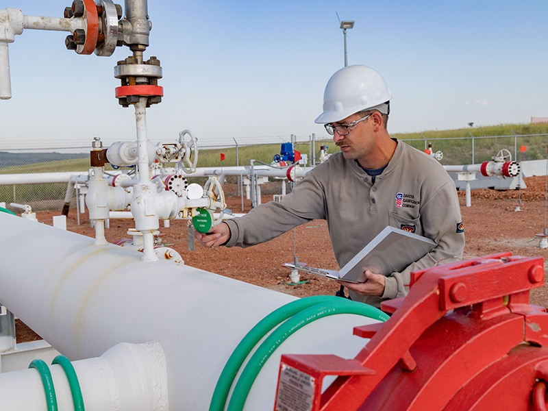 Hunter Eslinger does routine checks on pipelines at Dakota Gas in early July near Beulah, North Dakota. He says the most important part of his job is ensuring the integrity of the pipelines, that products at Dakota Gas are ‘delivered in a safe, reliable, and cost-effective way through the pipeline.’