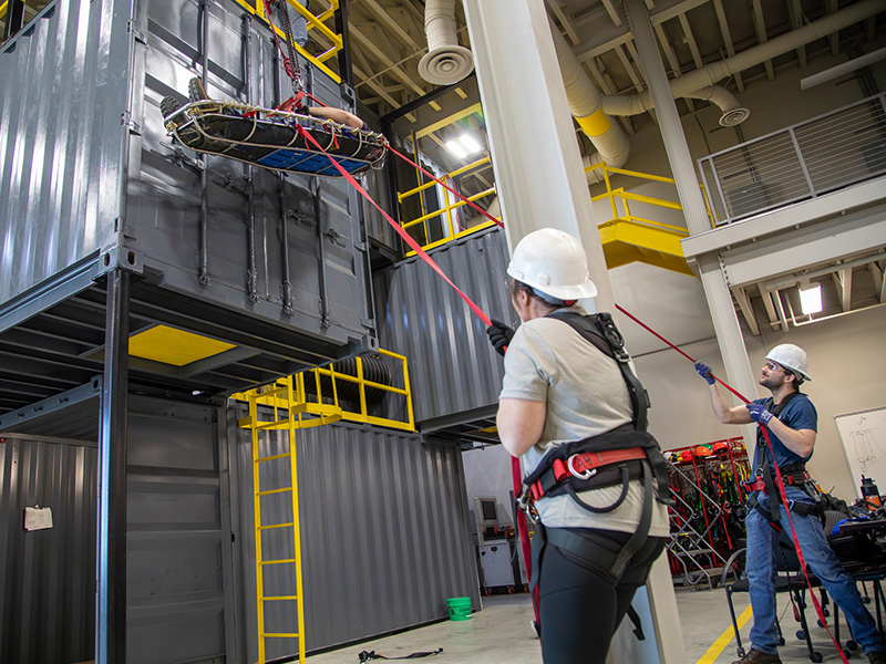 Two Dakota Gas employees practice a rope rescue