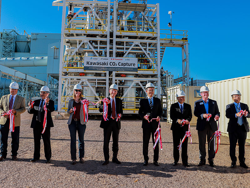 ribbon cutting outside power plant