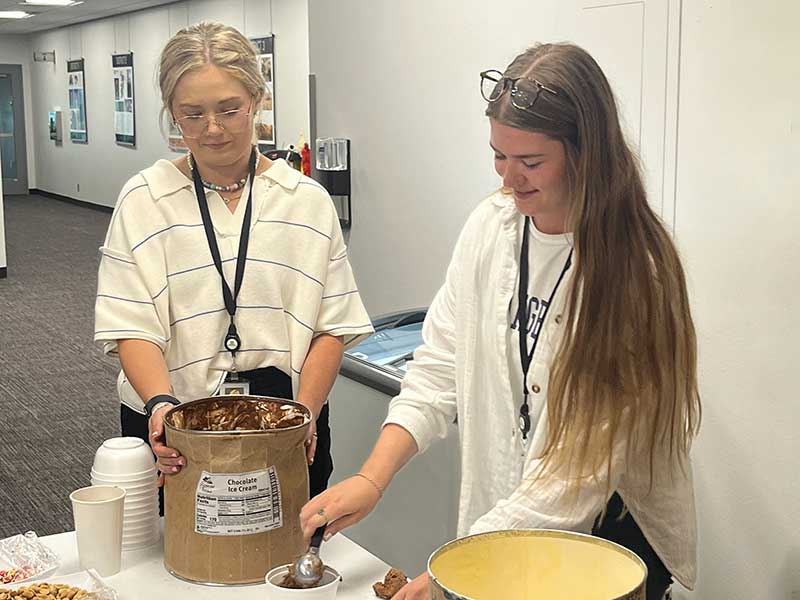 Two women serving ice cream